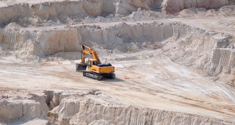 Heavy industrial equipment in open mine kaolinite quarry